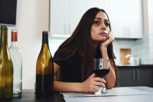 Women drinking wine looking sad